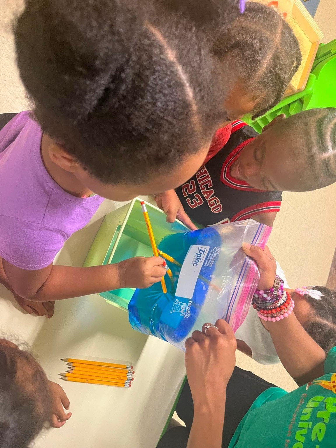 A teacher supporting a classroom experiment