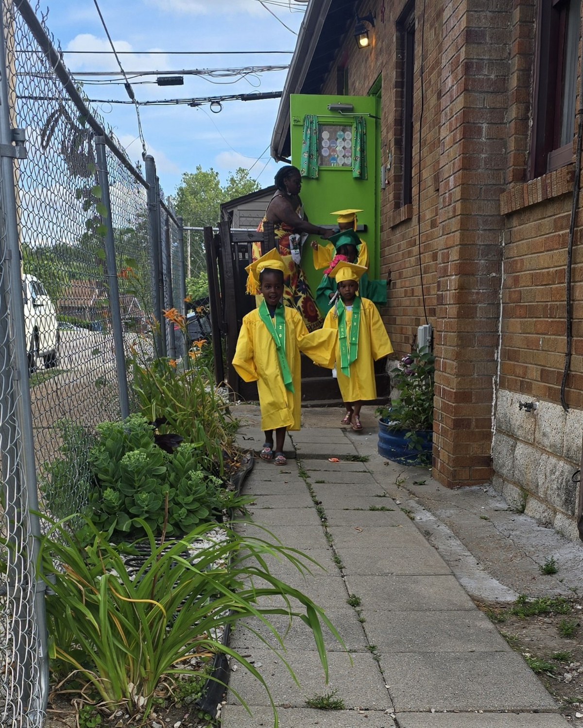Children in Pre-K University graduation caps and gowns